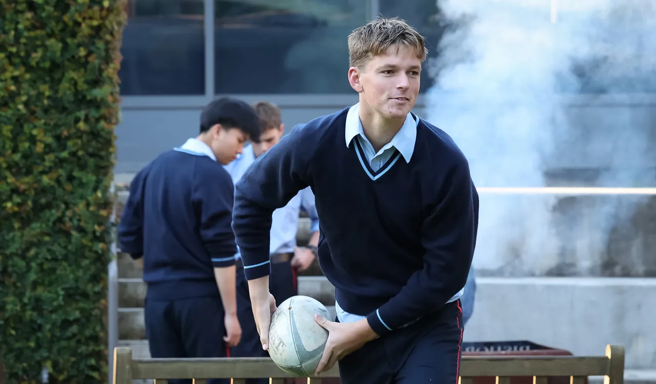 Boy passing rugby ball
