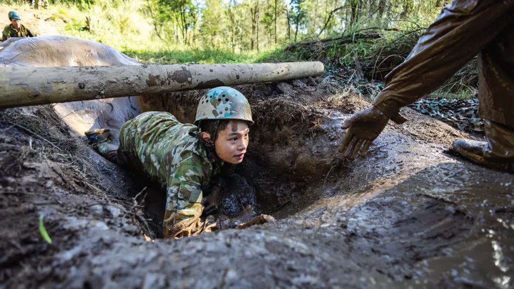 Boy navigating obstacle at Corps Camp.